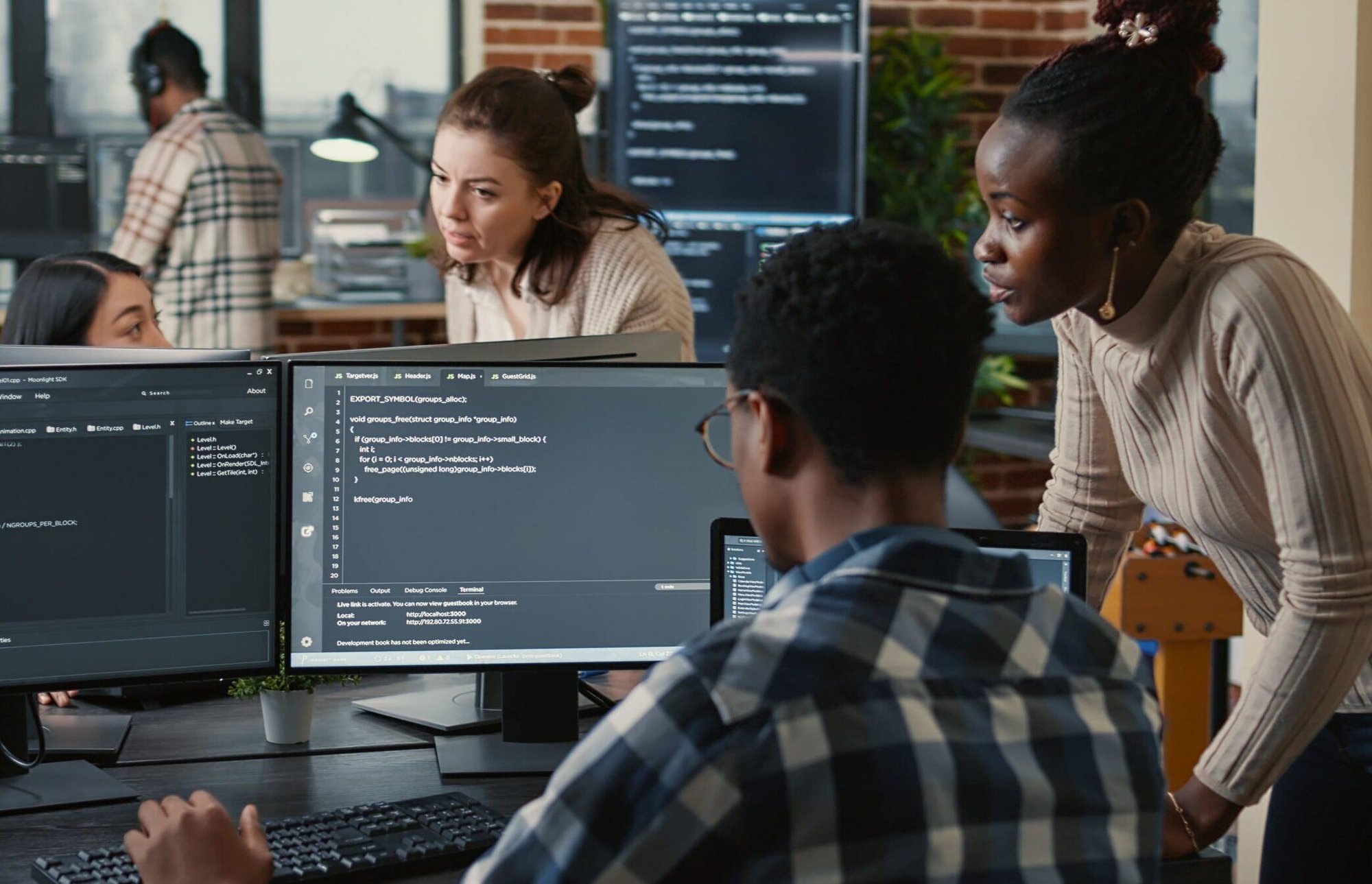 Diverse-group-of-people-around-computers-in-an-office